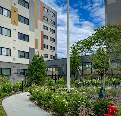 an outdoor courtyard with a fire hydrant in front of an apartment building